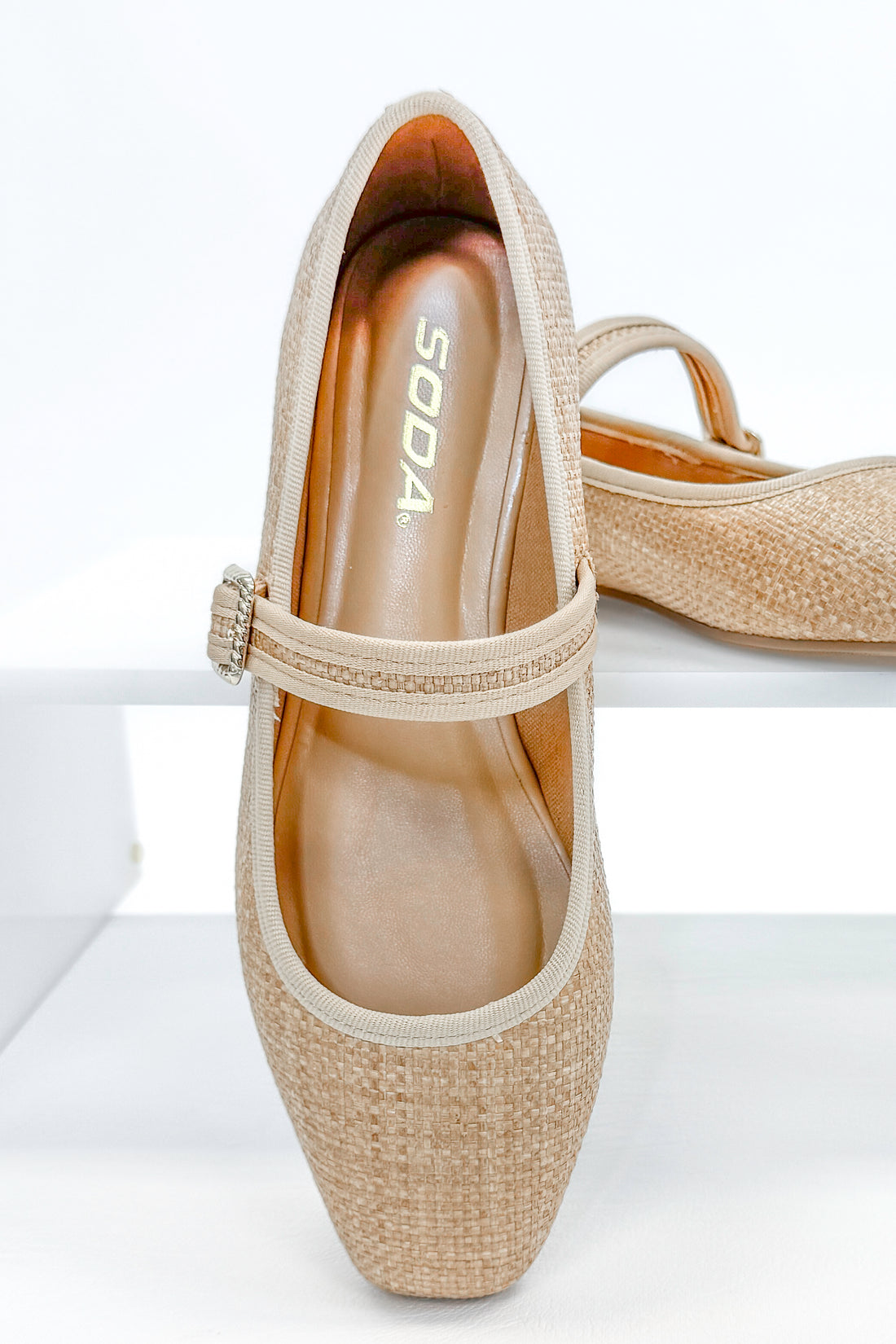 Adora- Natural Raffia Flats against white studio background.