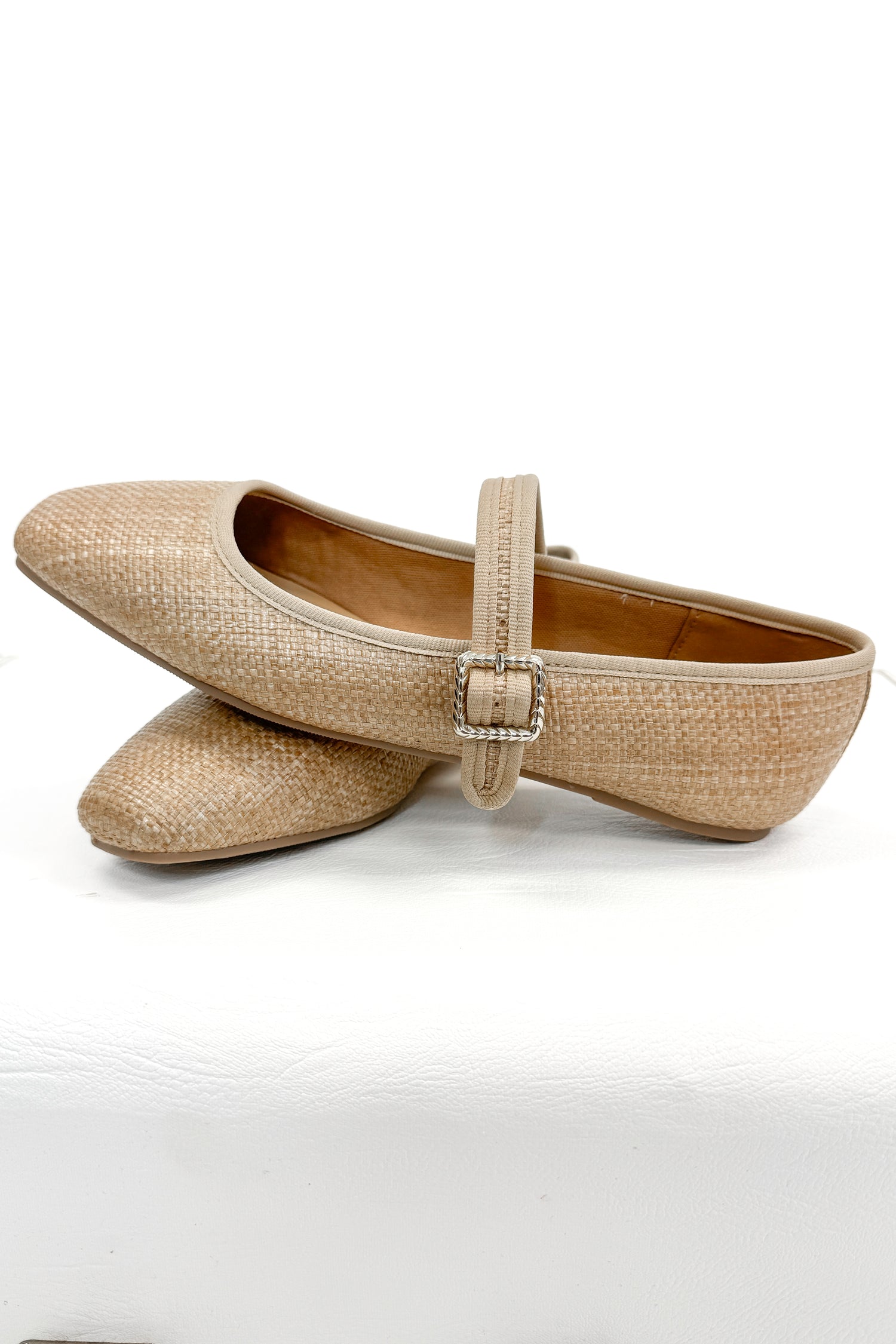 Adora- Natural Raffia Flats against white studio background side view.