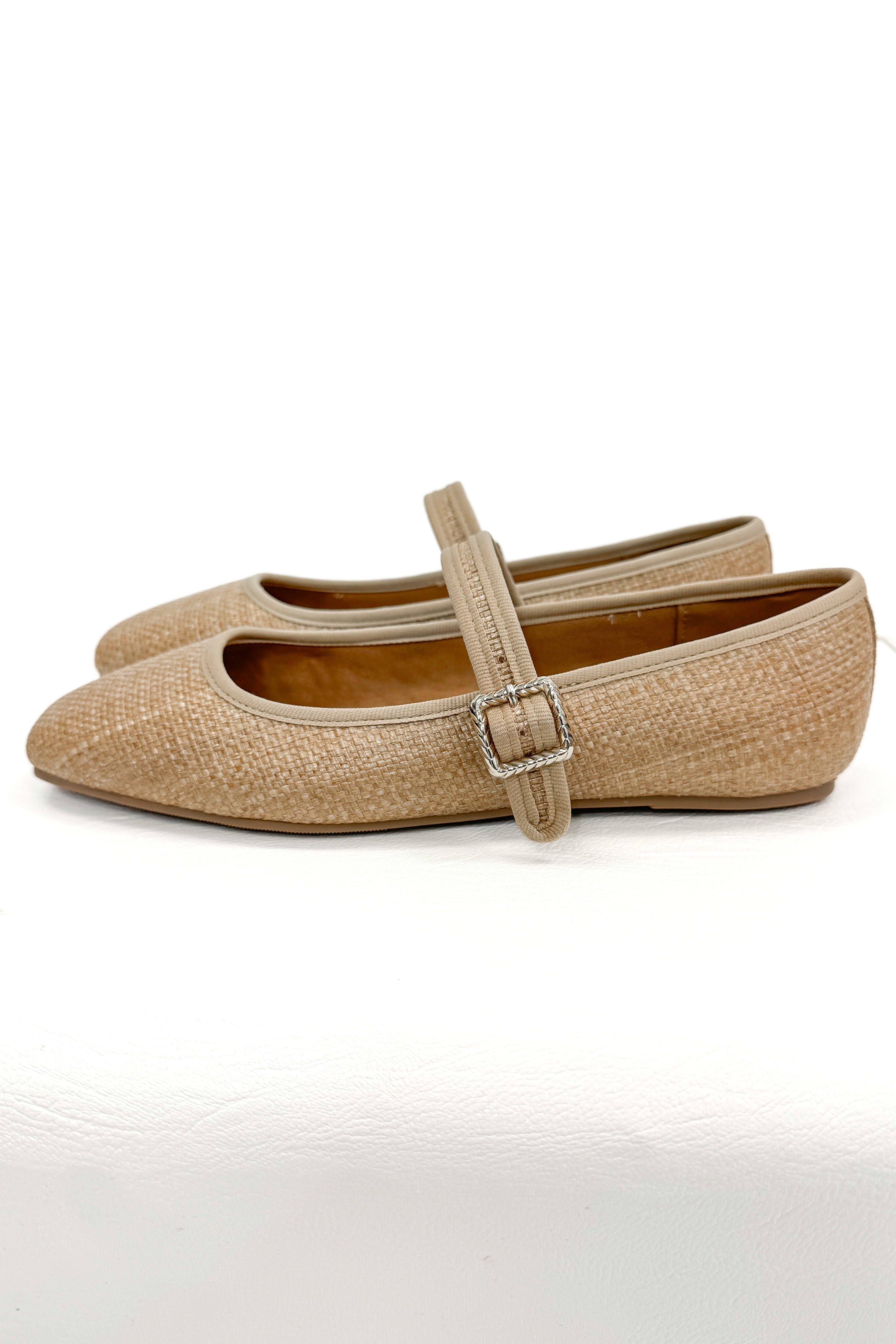 Adora- Natural Raffia Flats against white studio background side view.