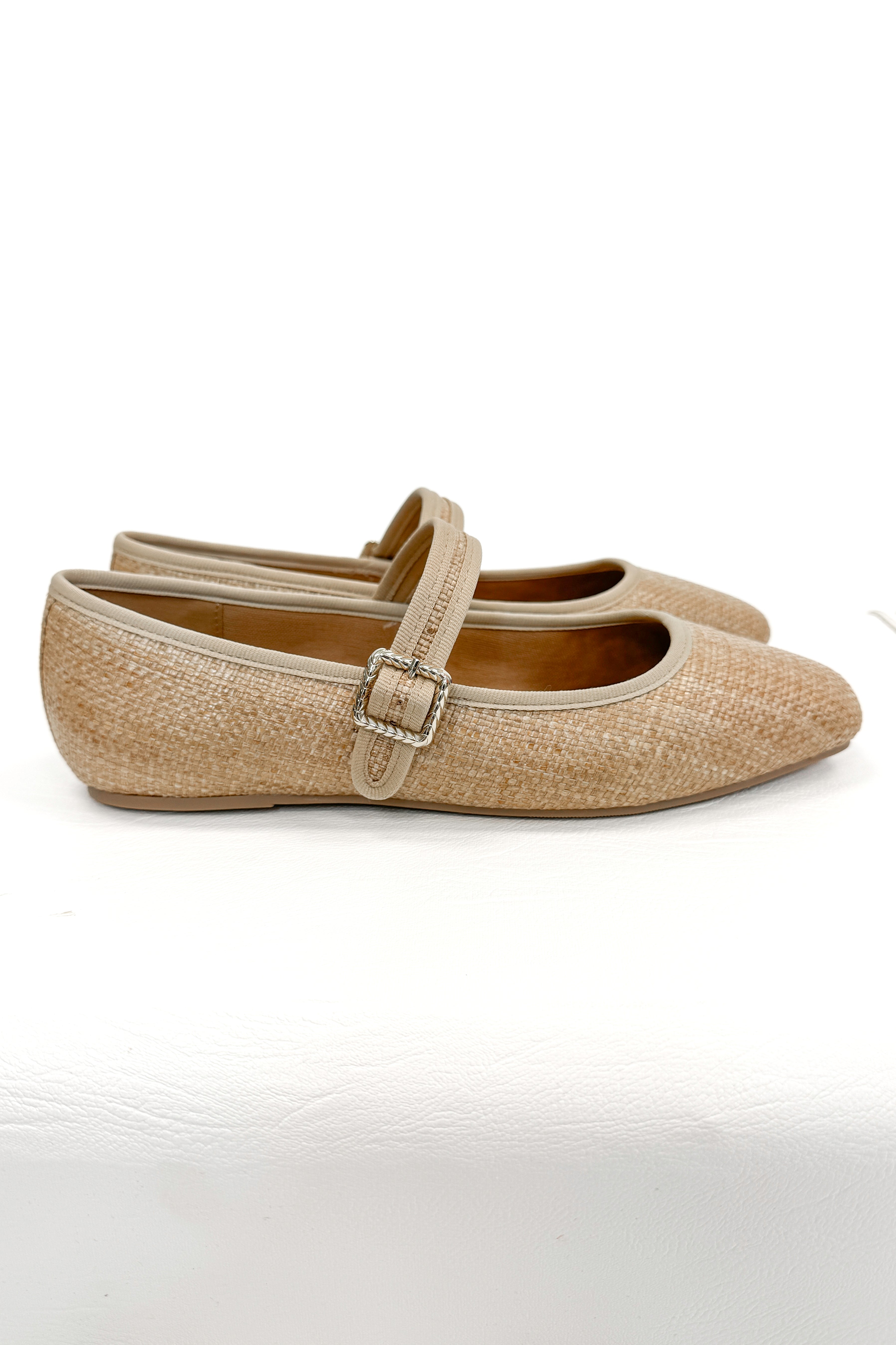 Adora- Natural Raffia Flats against white studio background side view.