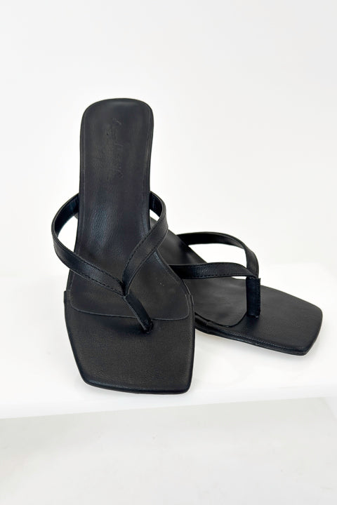 Align- Black Thong Kitten Heels against white studio background.