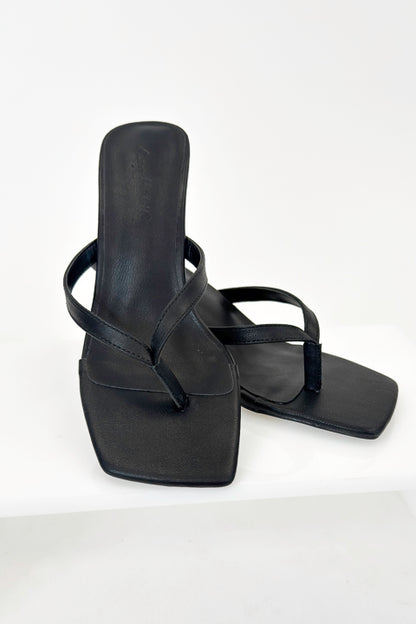 Align- Black Thong Kitten Heels against white studio background.