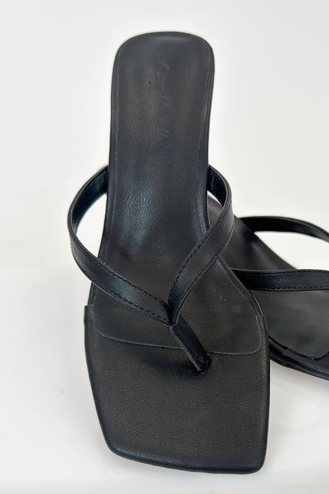 Align- Black Thong Kitten Heels against white studio background.