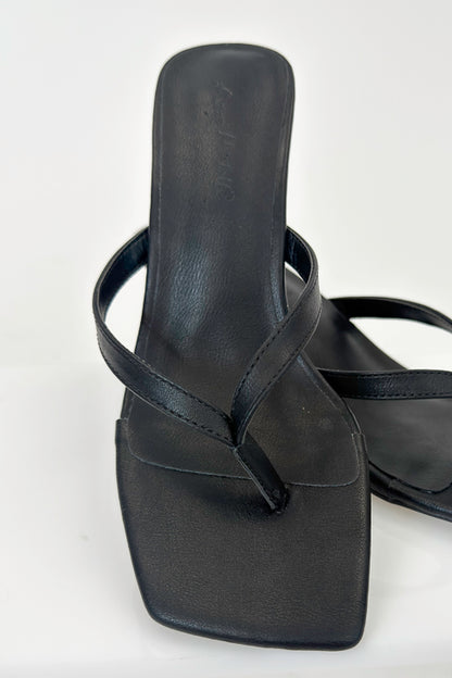 Align- Black Thong Kitten Heels against white studio background.