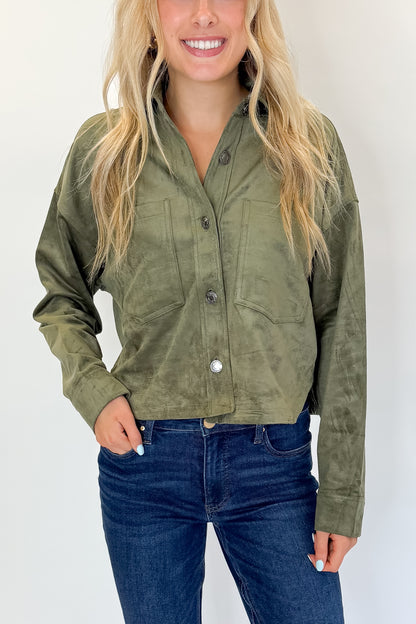 Front detail view of woman wearing Swagger Boutique’s Monstera All Day Cropped Suede Jacket by Z Supply with jeans against white studio background.