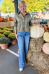 Front view of woman wearing Swagger Boutique’s Monstera All Day Cropped Suede Jacket by Z Supply with jeans standing at a pumpkin patch.