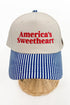 Front view of a striped-brim trucker hat with “America’s Sweetheart” embroidered on the front. 