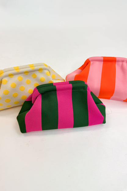 Three colorful pouches with polka dots and stripes on a white background