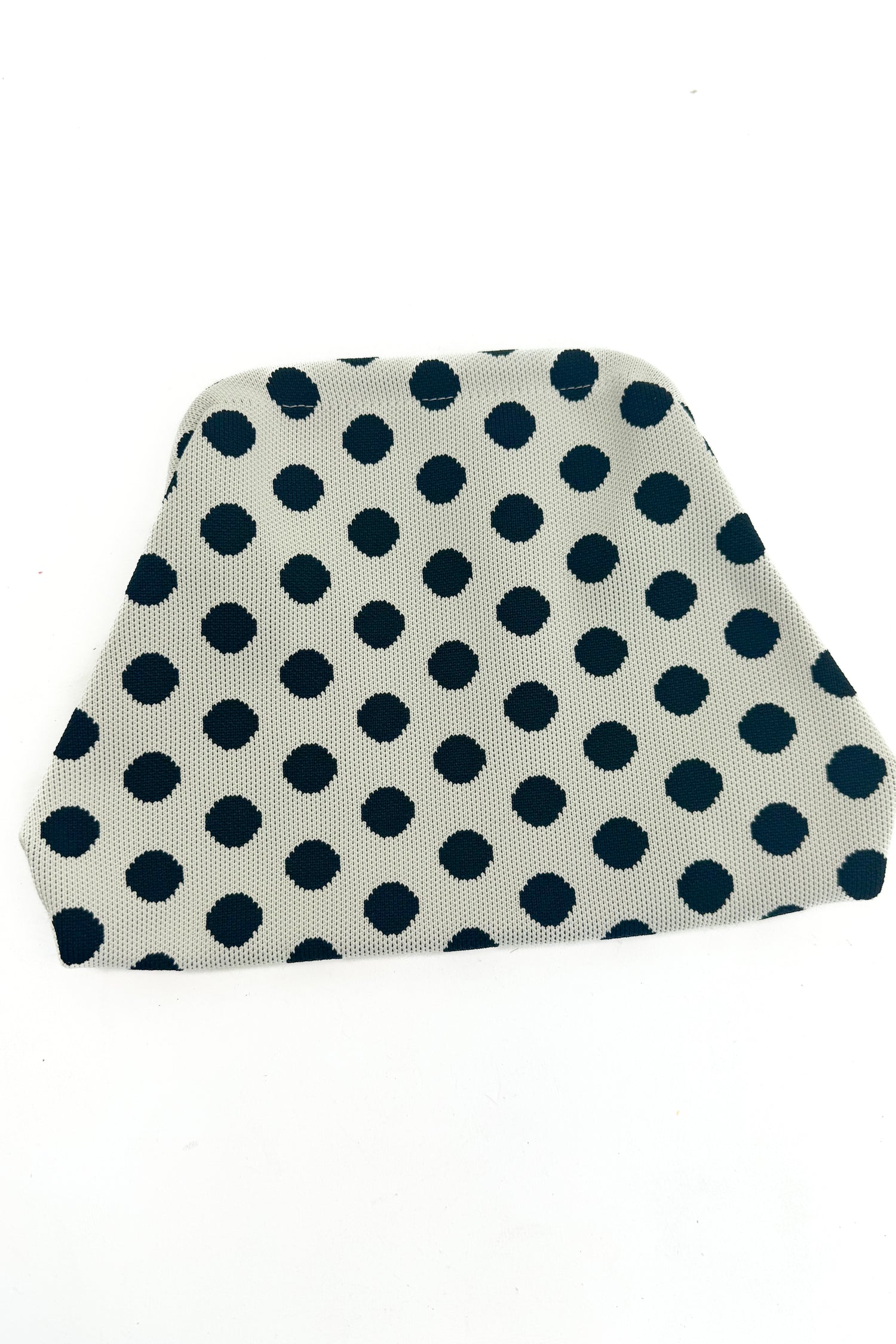 Beige fabric pouch black polka dots on a white background