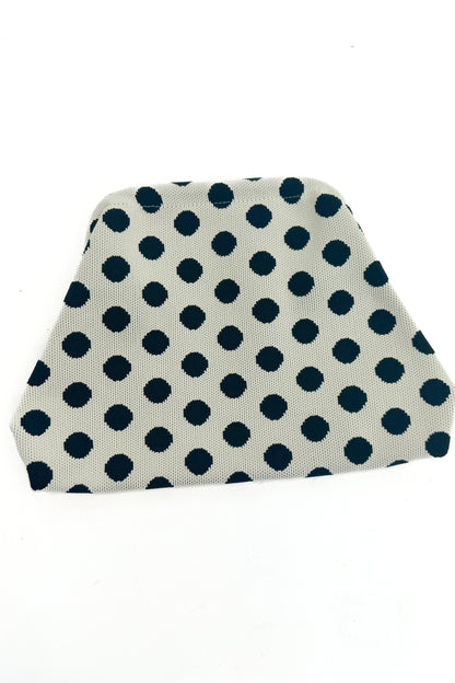Beige fabric pouch black polka dots on a white background
