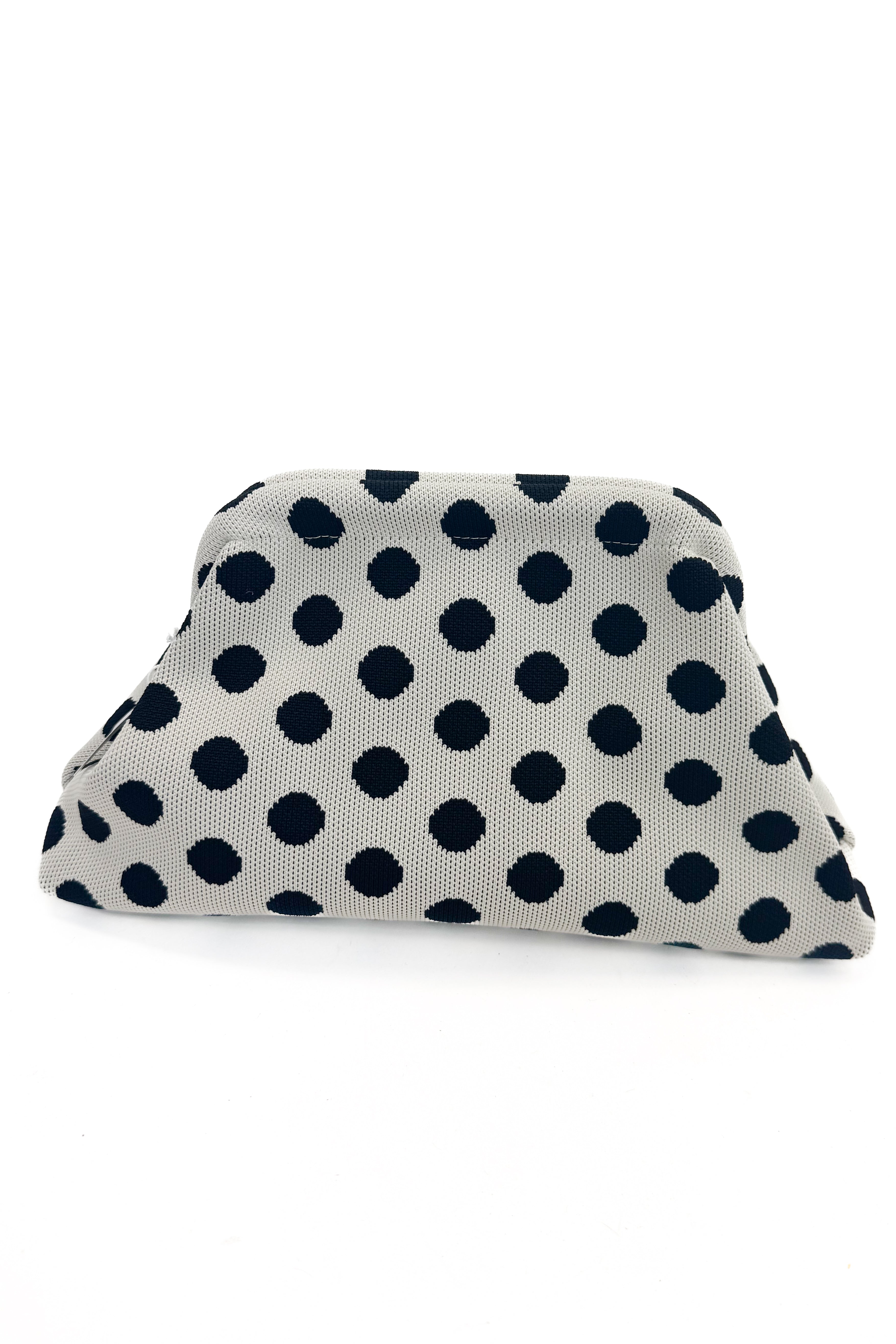 Beige fabric pouch with black polka dots on a white background