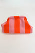 Pink and orange striped pouch on a white background