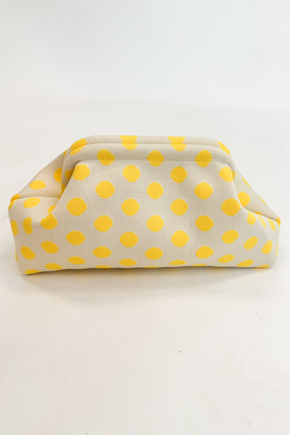 Beige fabric pouch with yellow polka dots on a white background