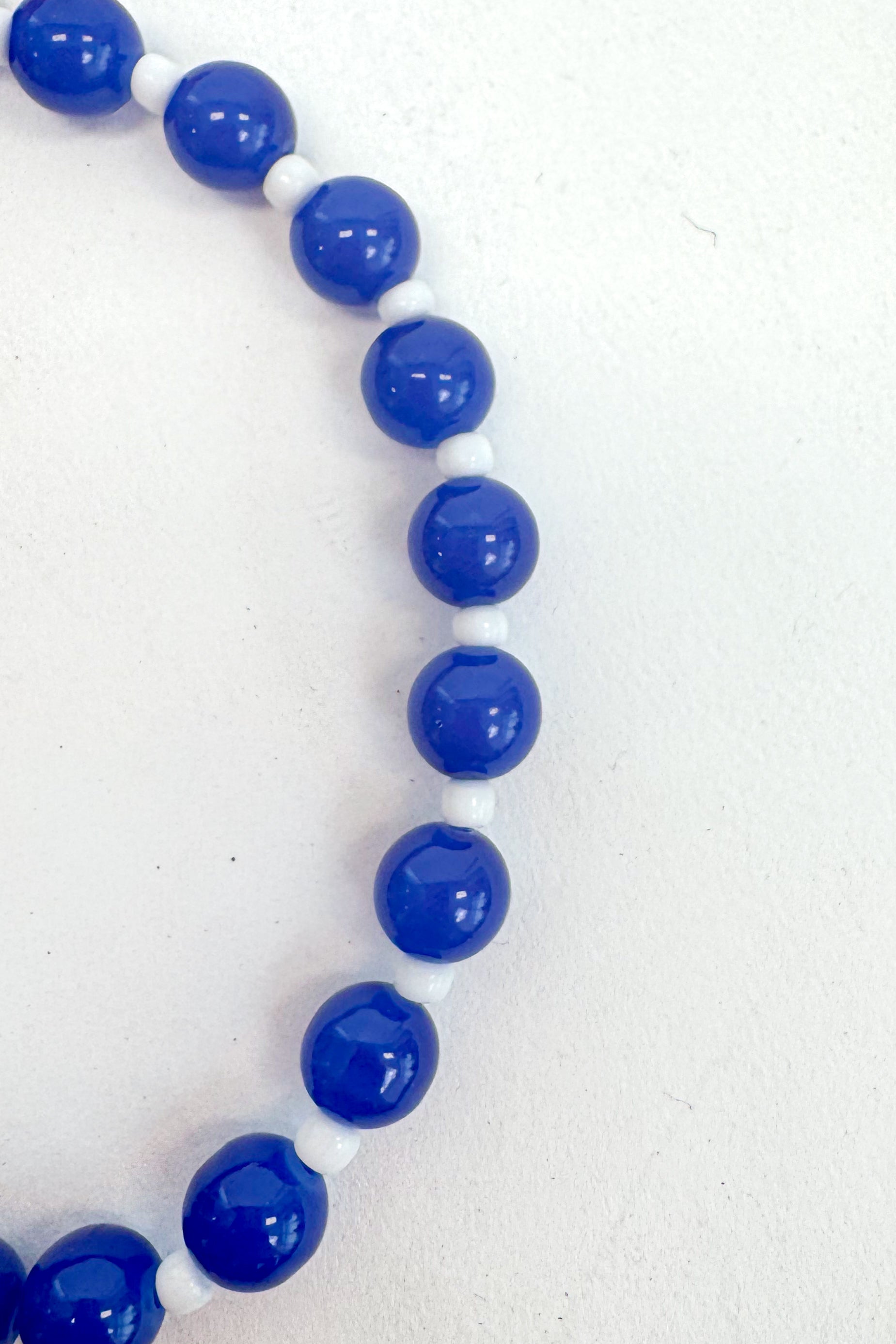 Necklace with blue beads on a white background