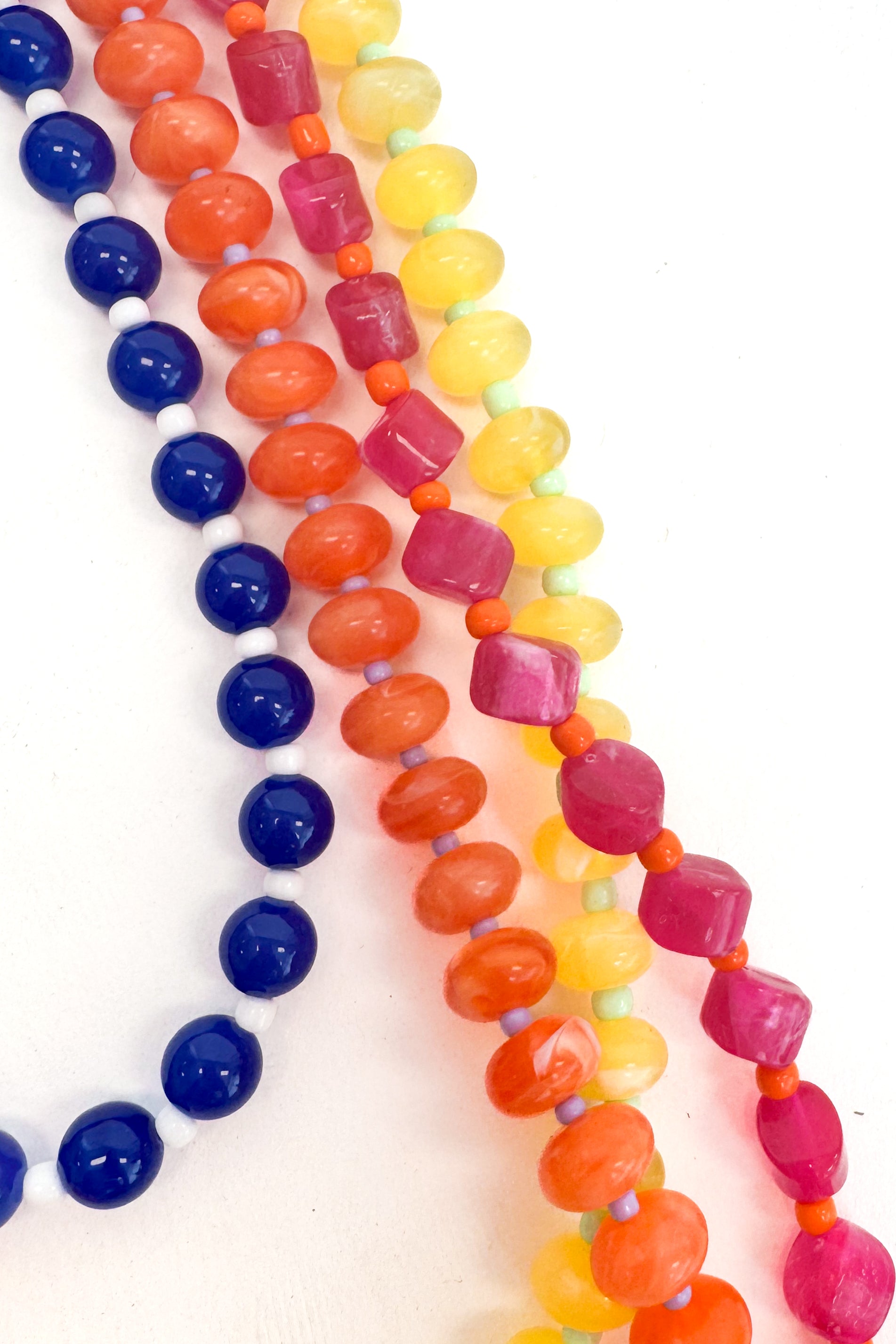 Colorful beaded necklaces on a white background