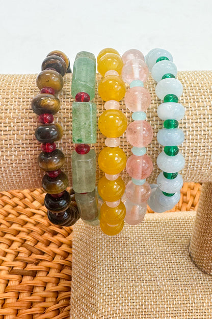 Set of colorful beaded bracelets on a woven surface