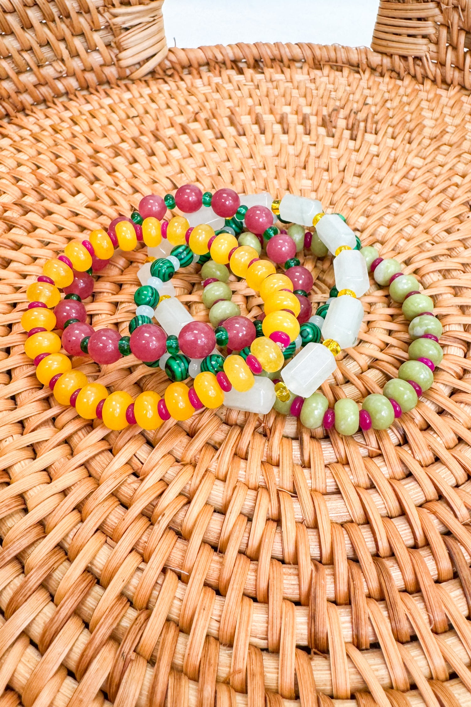 Colorful beaded bracelets on a woven surface