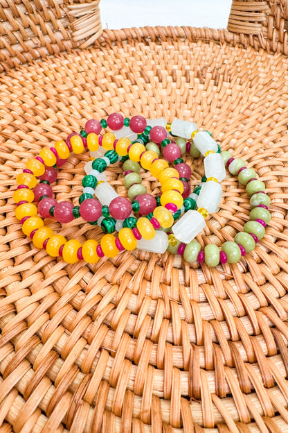 Colorful beaded bracelets on a woven surface