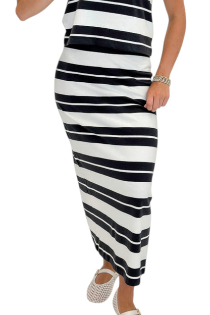 Front detail view of woman wearing Swagger Boutique’s Ash Black Stellan Striped Tee by Z Supply with Ash Black Gail Striped Jersey Midi Skirt by Z Supply against white studio background.