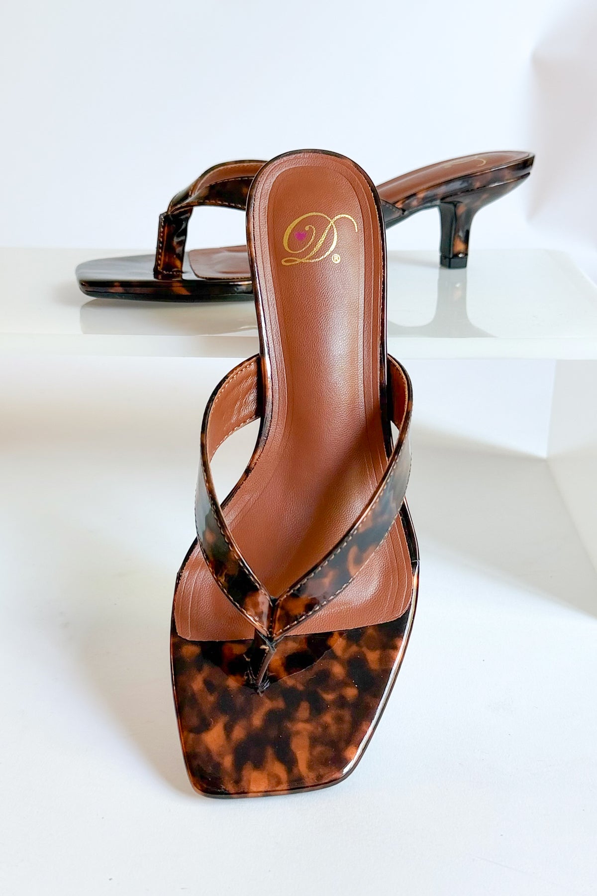 Azalea- Tortoise Thong Kitten Heel against white studio background