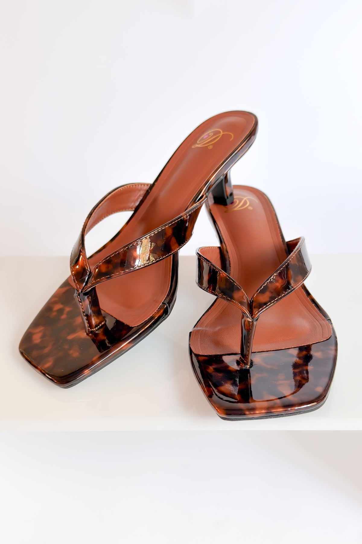 Azalea- Tortoise Thong Kitten Heel against white studio background