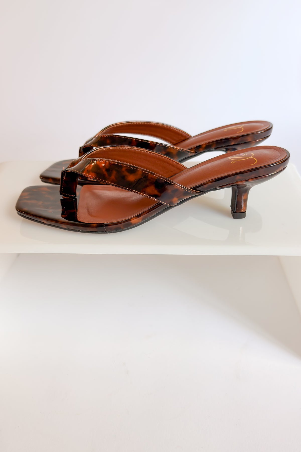 Azalea- Tortoise Thong Kitten Heel against white studio background side view