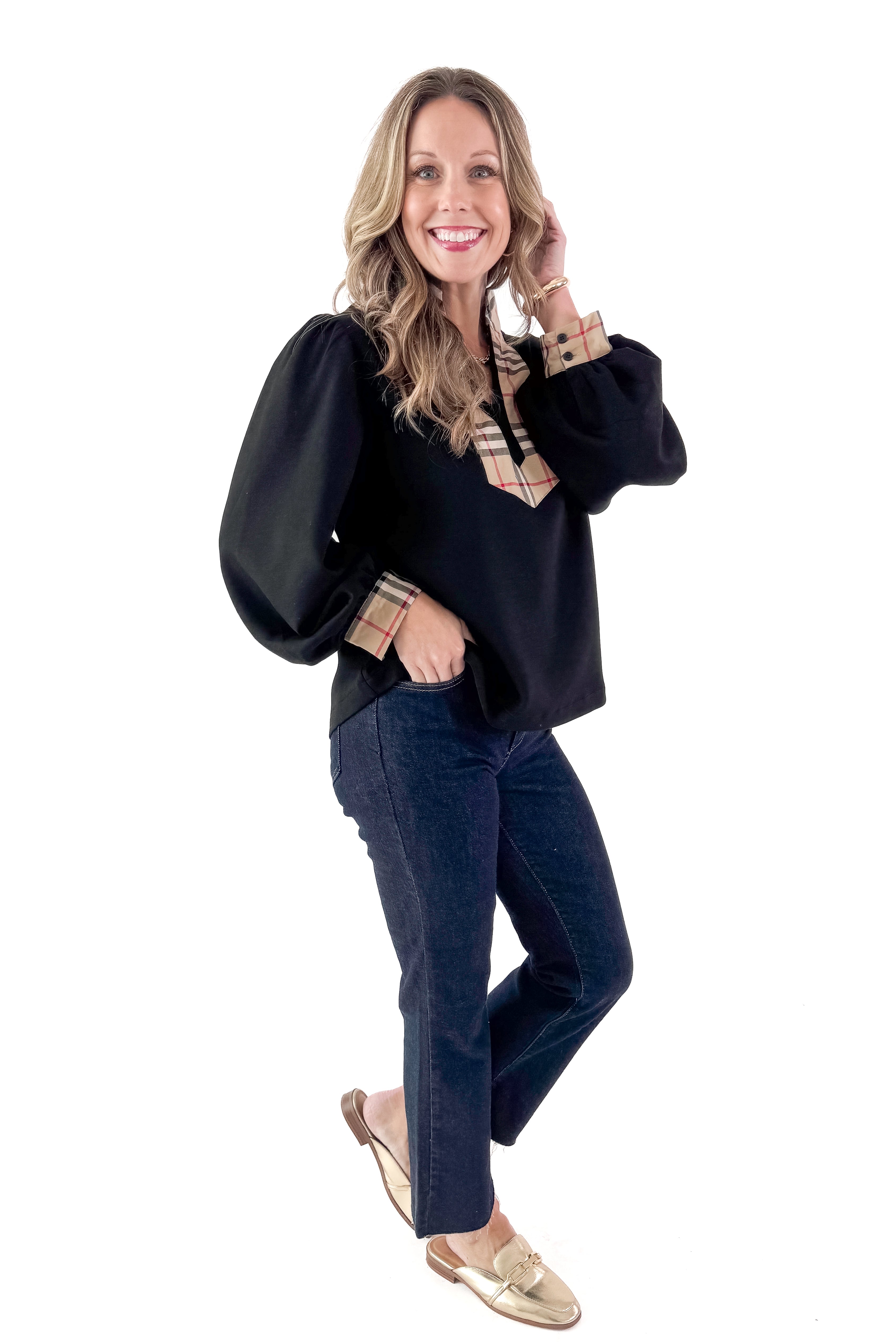 Side view of woman wearing Black With Plaid Contrast Detail Top with jeans against white studio background.