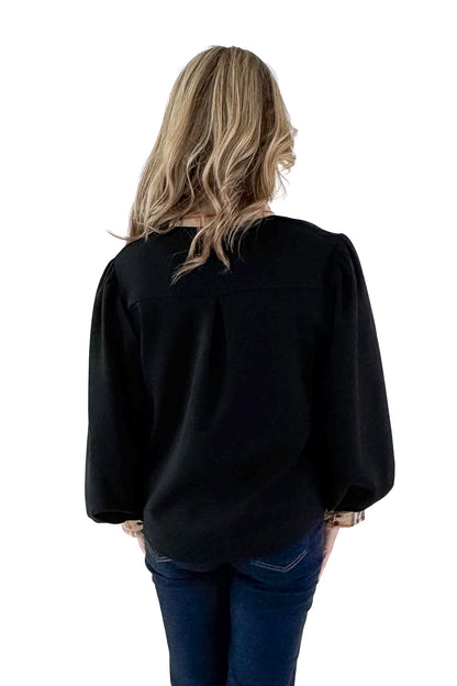 Back view of woman wearing Black With Plaid Contrast Detail Top with jeans against white studio background.