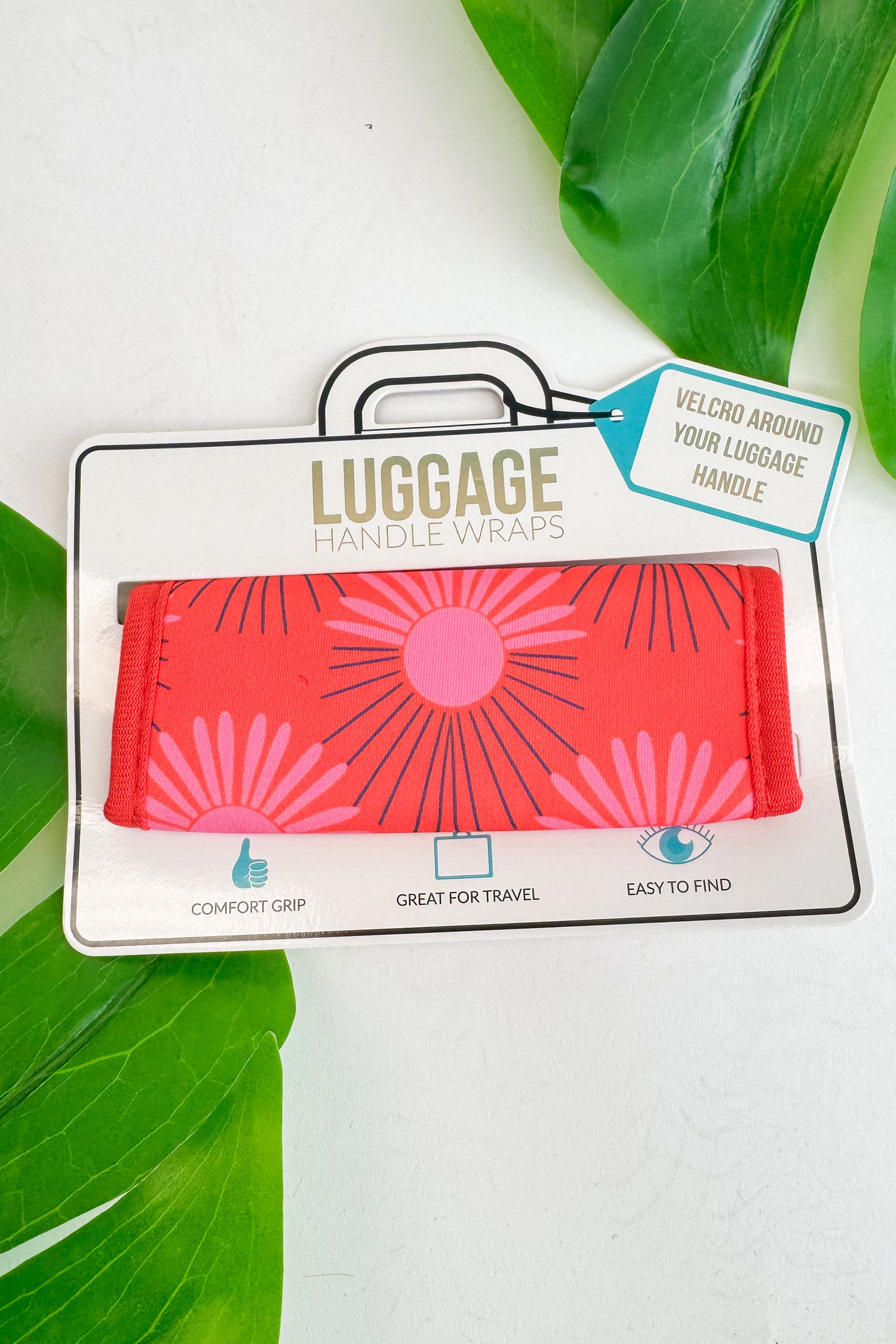 Luggage handle wrap with pink design on a white background