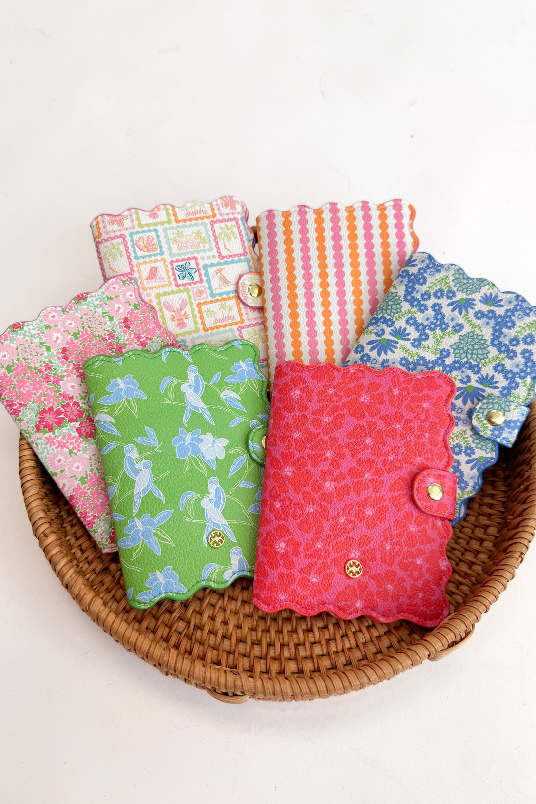 Basket with colorful fabric-covered books on a white background