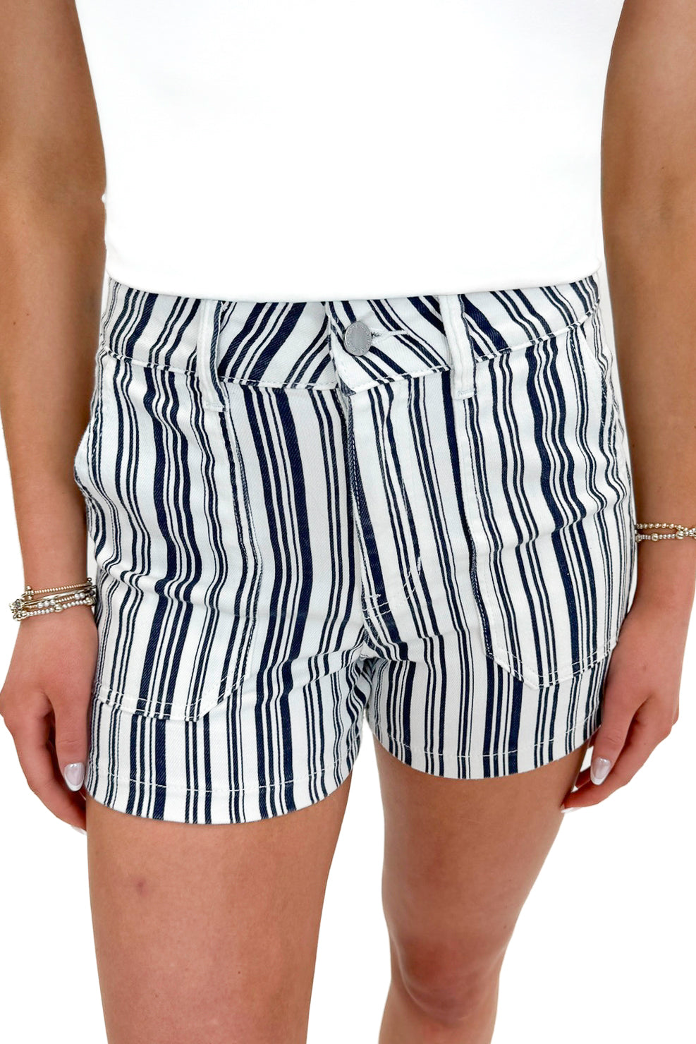 Front detail view of woman wearing Navy Striped Cargo Shorts by Just Black Denim with tank against white studio background.