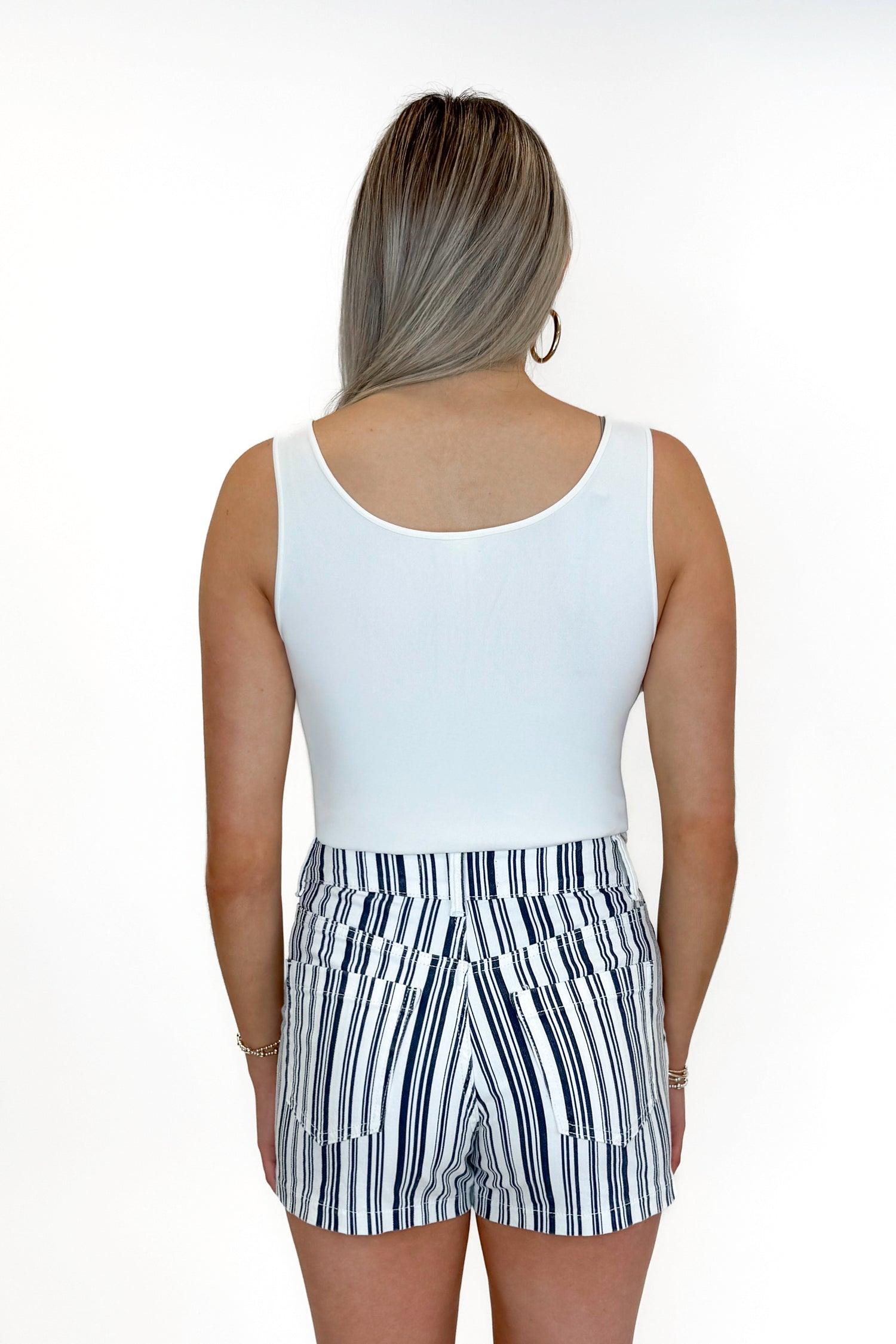 Back view of woman wearing Navy Striped Cargo Shorts by Just Black Denim with tank against white studio background.