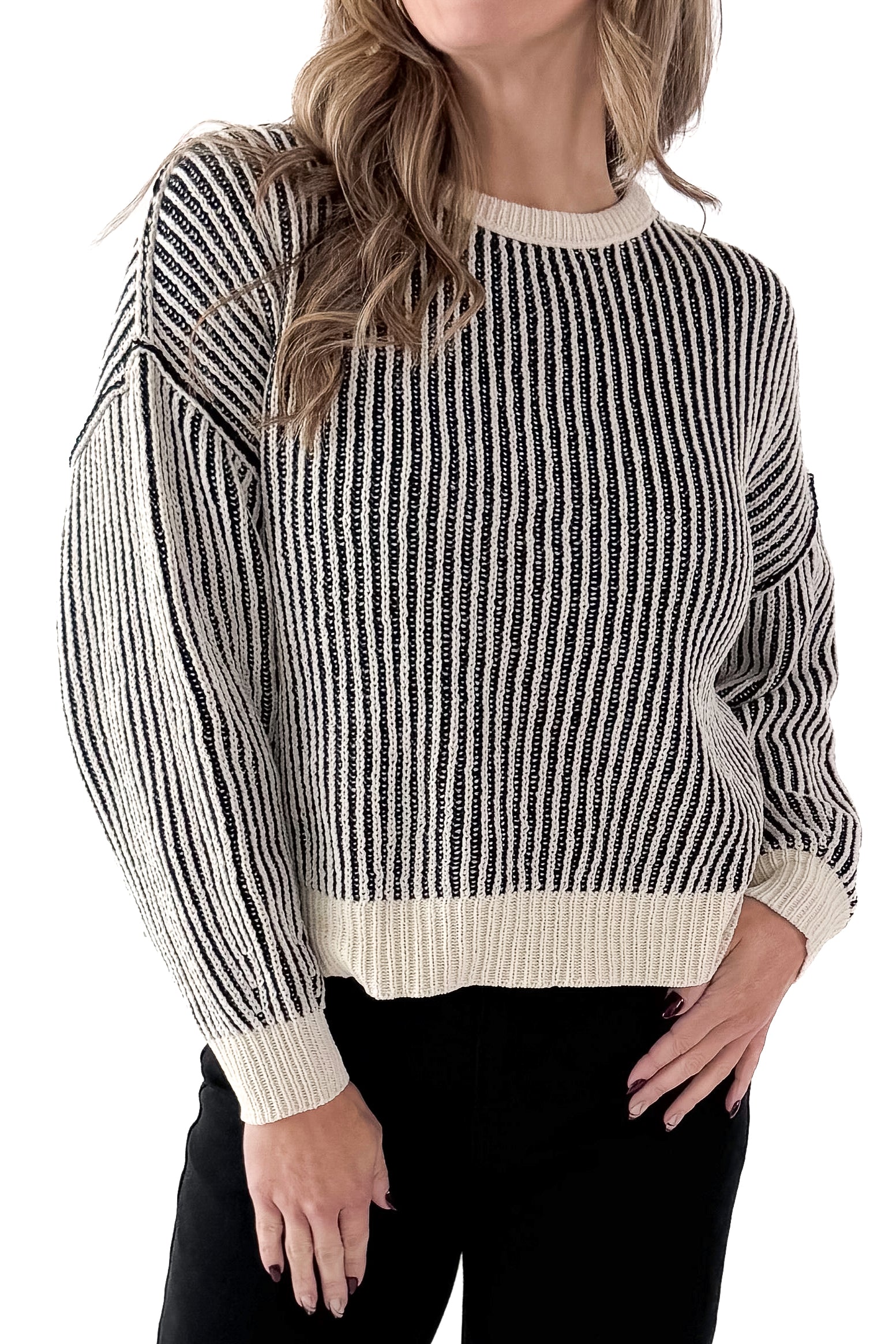 Front detail view of woman wearing Black &amp; Cream Striped Sweater with jeans against white studio background.