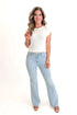 Front view of woman wearing Light Wash Flare Jeans by Just Black Denim with white sweater against white studio background.