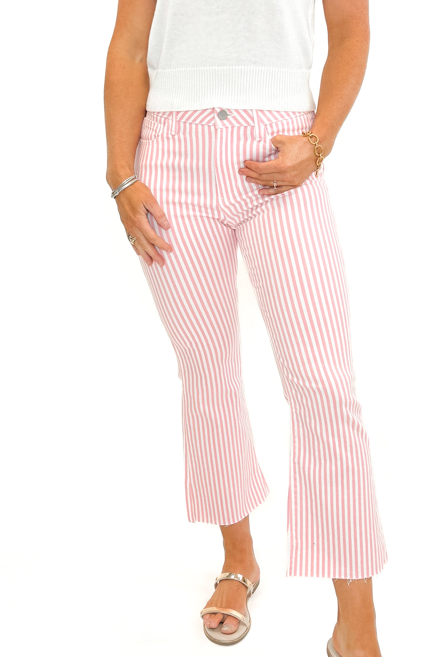 Front view of woman wearing Pink Striped Crop Flare Jeans by Just Black Denim with white top against white studio background.