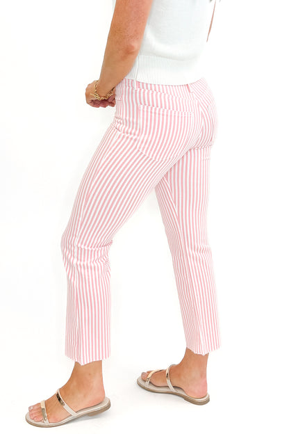 Side view of woman wearing Pink Striped Crop Flare Jeans by Just Black Denim with white top against white studio background.