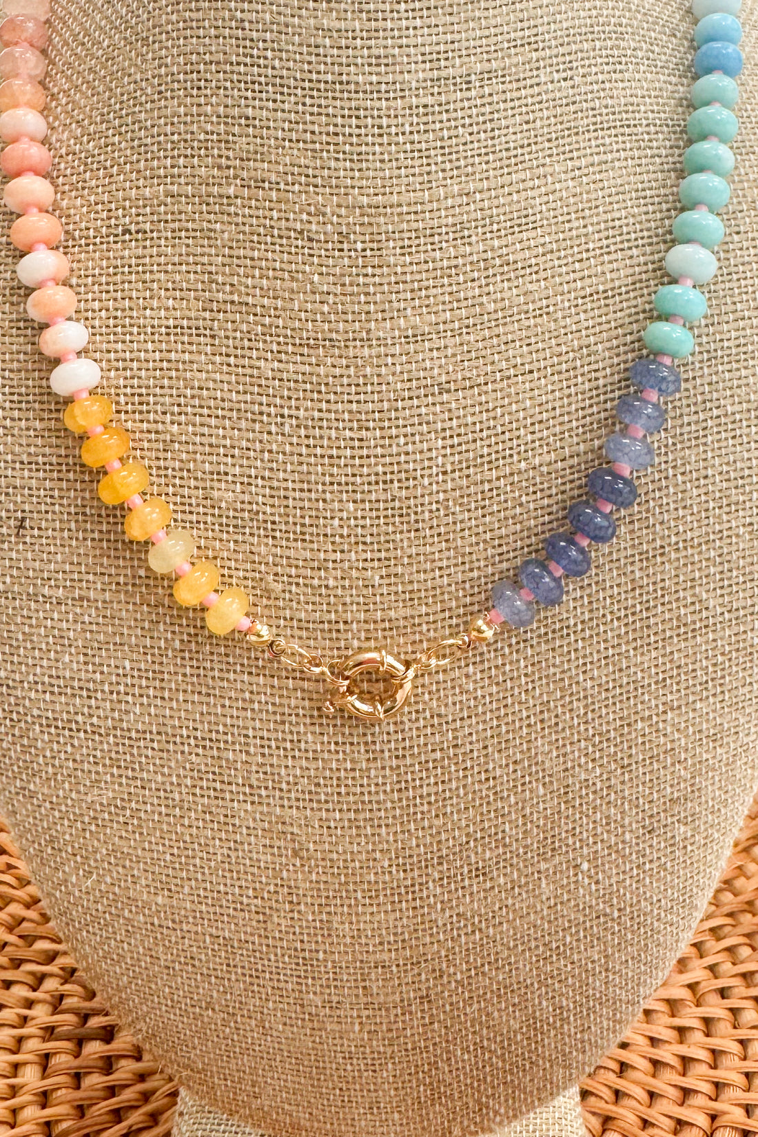 Necklace with multicolored beads on a beige surface