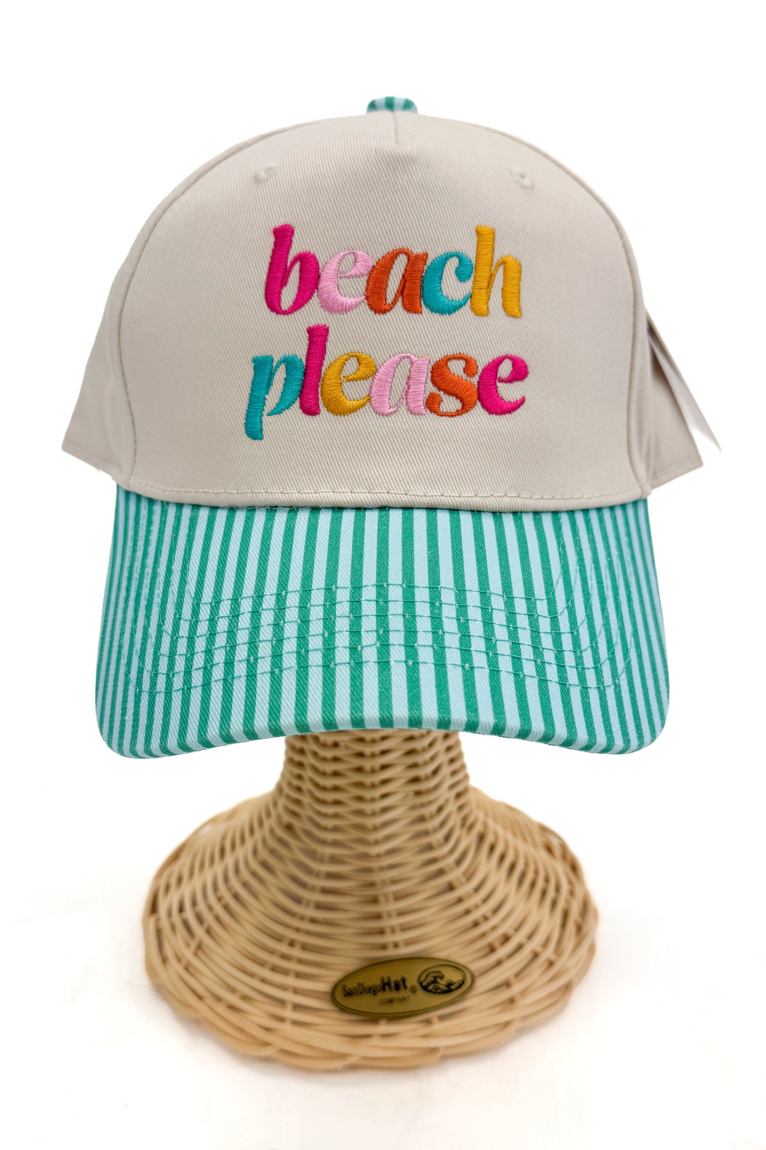 Front view of a striped-brim trucker hat with “beach please” embroidered on the front. 