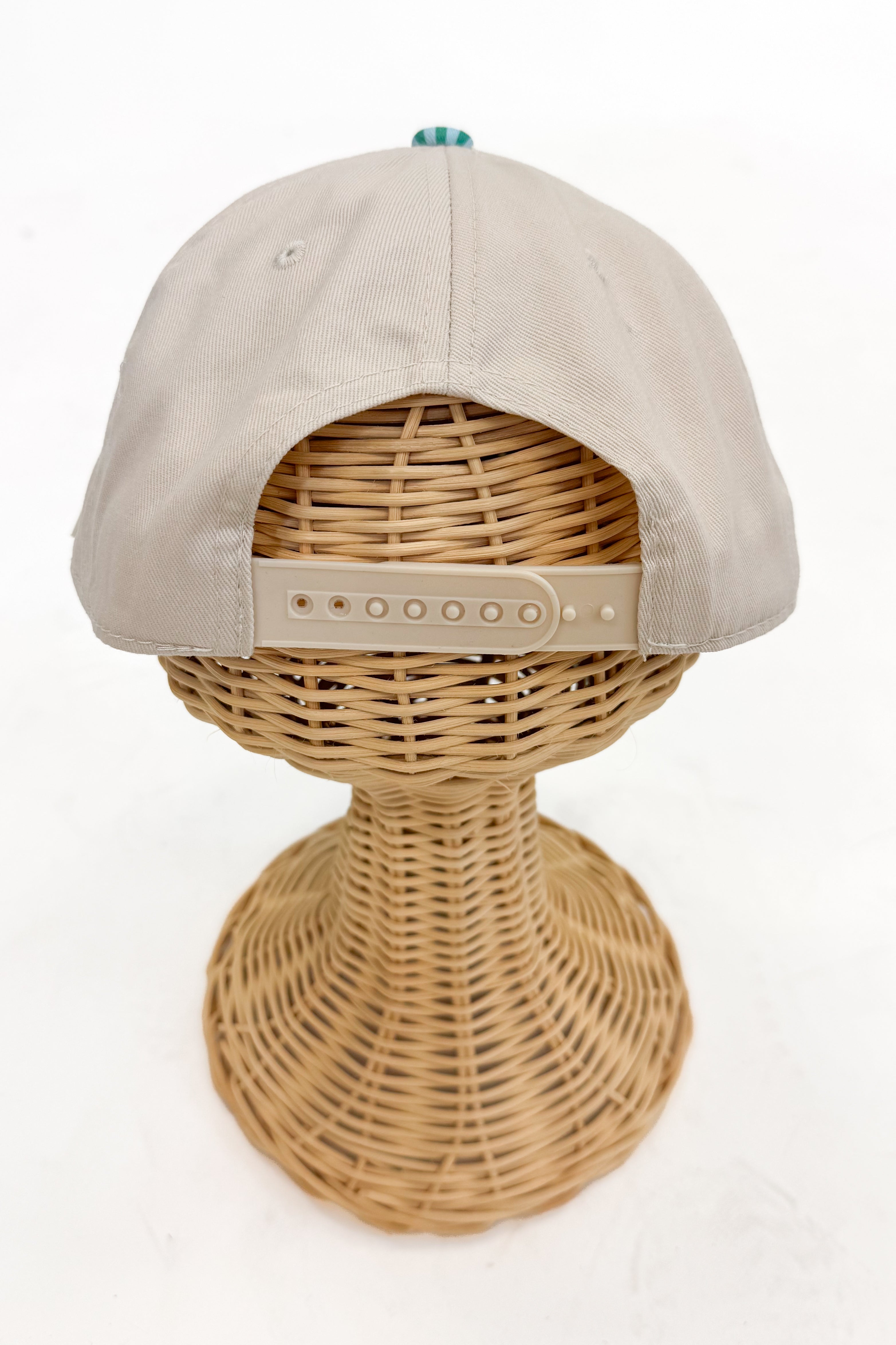Back view of the striped-brim vintage hat featuring an adjustable strap closure.