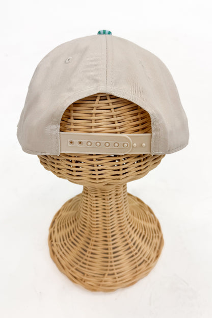 Back view of the striped-brim vintage hat featuring an adjustable strap closure.