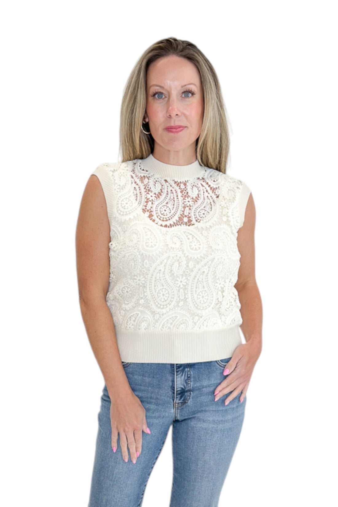 Front view of woman wearing Swagger Boutique’s Beige Crochet Front Sleeveless Sweater with jeans against white studio background.