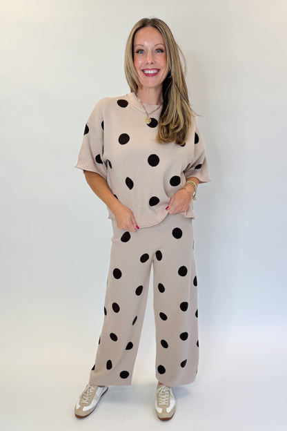 Front view of woman wearing Swagger Boutique’s Beige Polka Dot Short Sleeve Top &amp; Knit Pants against white studio background.