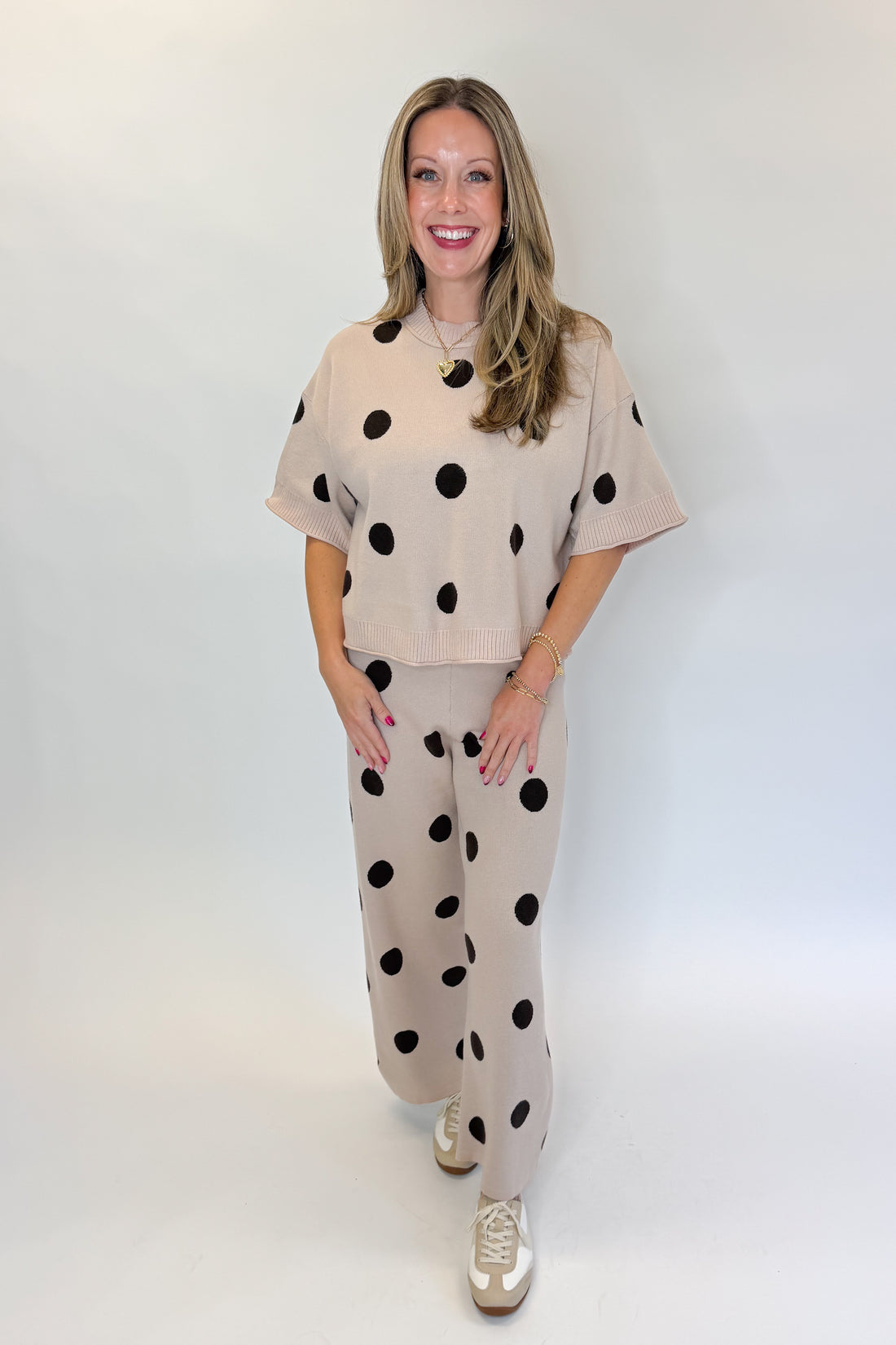 Front view of woman wearing Swagger Boutique’s Beige Polka Dot Short Sleeve Top &amp; Knit Pants against white studio background.