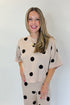 Front view of woman wearing Swagger Boutique’s Beige Polka Dot Short Sleeve Top & Knit Pants against white studio background.