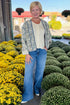 Front view of woman wearing Swagger Boutique’s Beige & Blue Printed Lightweight Jacket, Cream Sleeveless Button up Sweater with Maya Denim Jeans at a garden center.