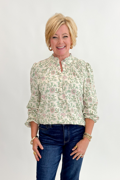 Front view of woman wearing Swagger Boutique’s Beige &amp; Olive Floral Long Sleeve Top with jeans against white studio background.