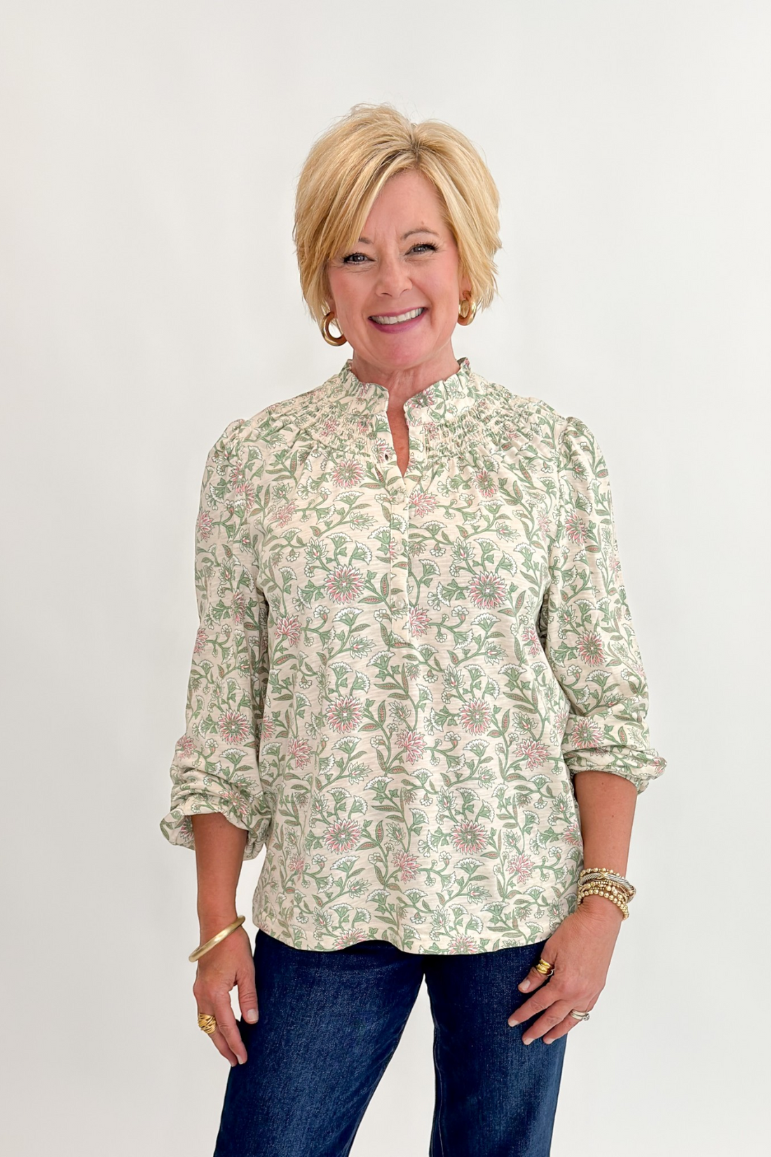 Front view of woman wearing Swagger Boutique’s Beige &amp; Olive Floral Long Sleeve Top with jeans against white studio background.