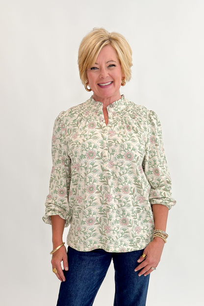 Front view of woman wearing Swagger Boutique’s Beige &amp; Olive Floral Long Sleeve Top with jeans against white studio background.