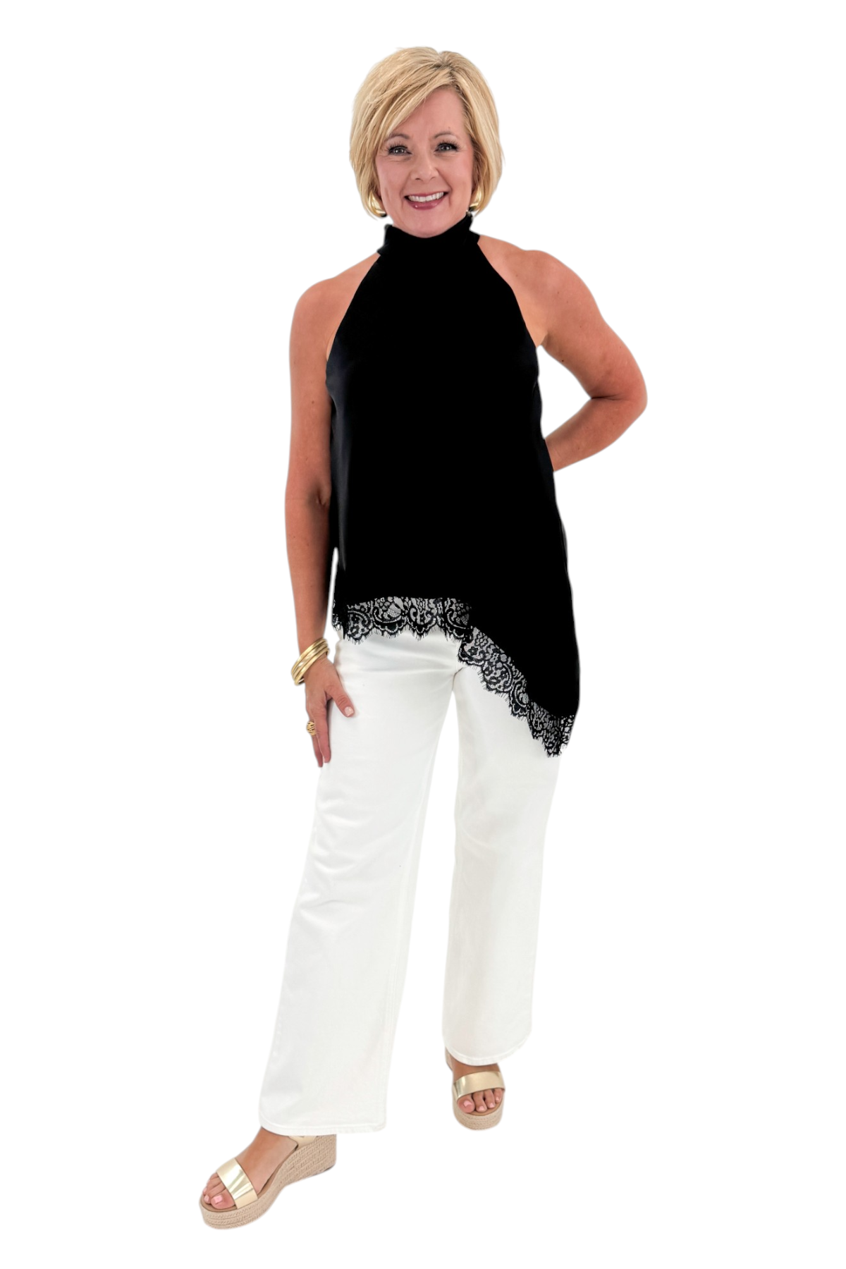 Front view of woman wearing Swagger Boutique’s Black Asymmetrical Halter Neck Satin Lace Top with jeans against white studio background.