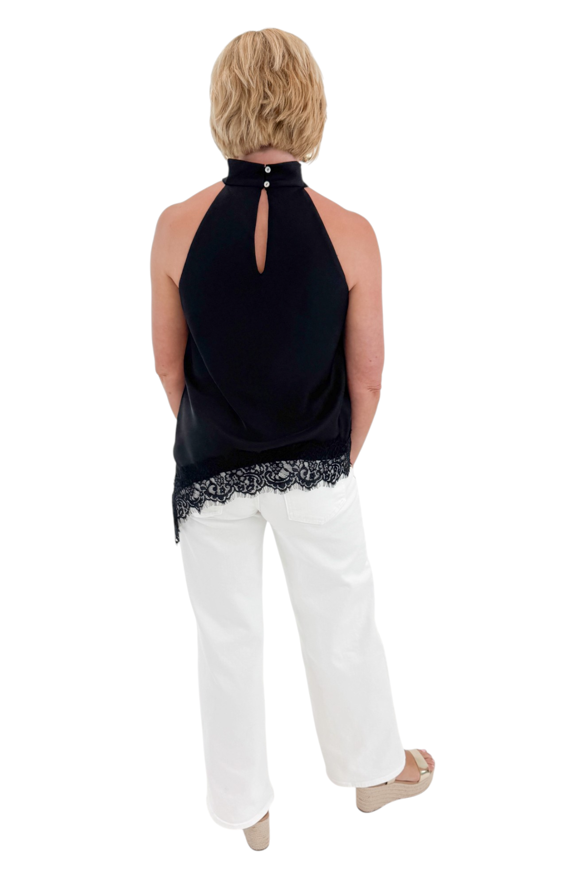 Back view of woman wearing Swagger Boutique’s Black Asymmetrical Halter Neck Satin Lace Top with jeans against white studio background.